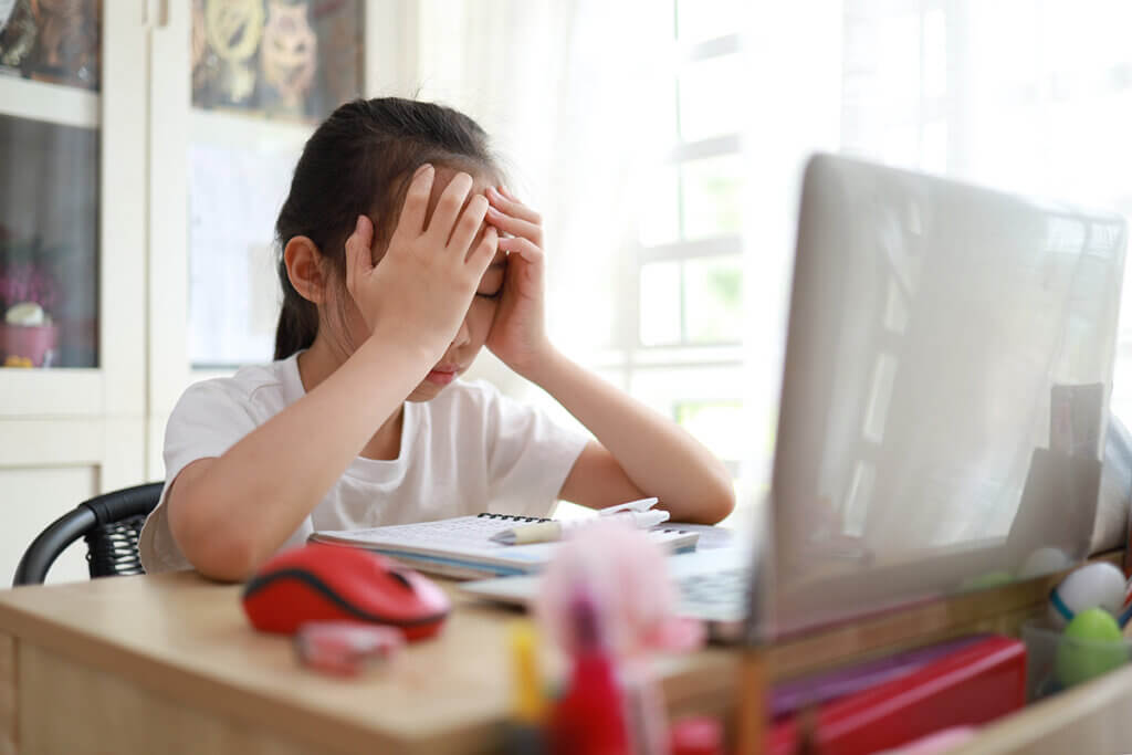 Girl looks at laptop upset