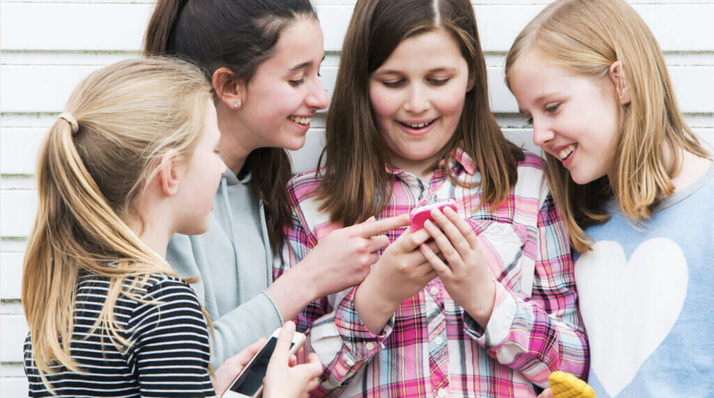 Group of girls look at content on a phone