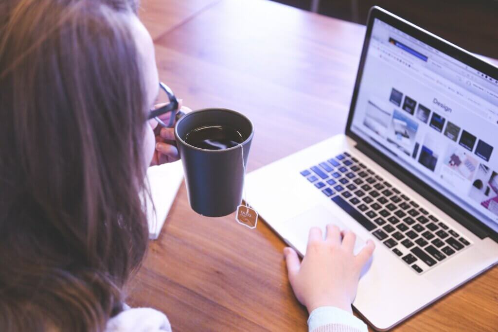 Adult using laptop on desk