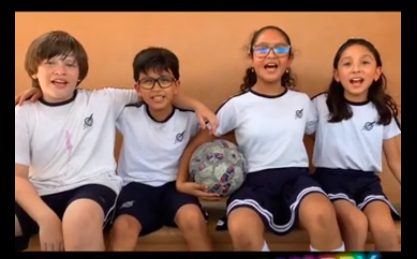 Young people sat on a bench playing football